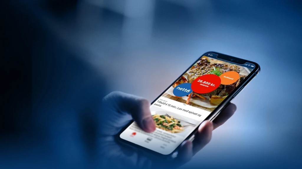 A person holding a smartphone displaying a grocery shopping app with food images and prices, focusing on a promotion for Netto.