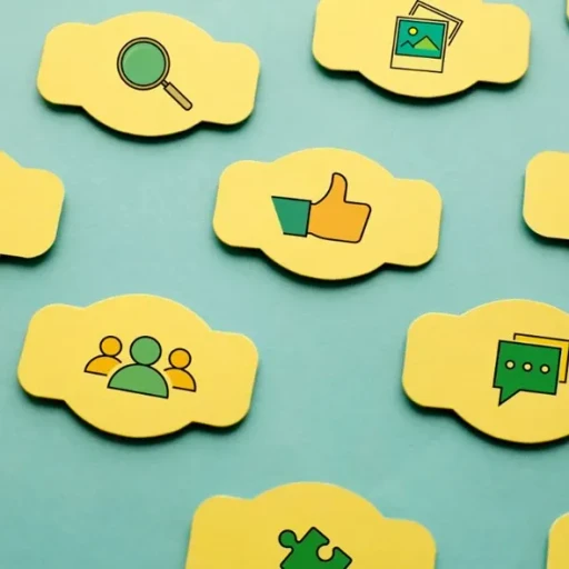 Colorful yellow speech bubbles with icons representing search, image, thumbs up, user groups, chat, and puzzle pieces arranged on a light blue background.