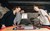 To mænd og en kvinde spiller bordfodbold i et rustikt rum i Vertica, der bygger prisvindende ecommerce løsninger