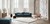 Rum med blå sofa, tæppe og stol fra Bolias onlinebutik